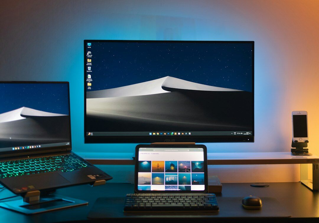 Mexican developer working with multiple monitors showing backend code