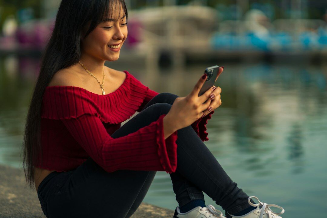 Young Mexican woman coding a mobile app on her laptop