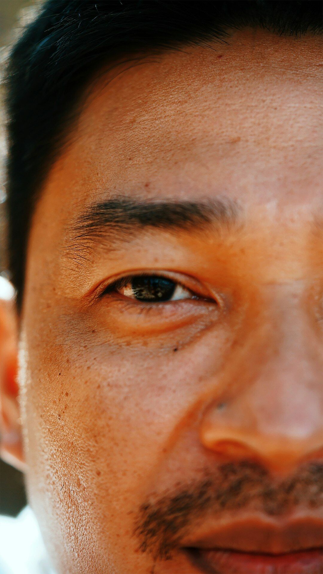 Close-up of a Mexican student's eye reflecting lines of code